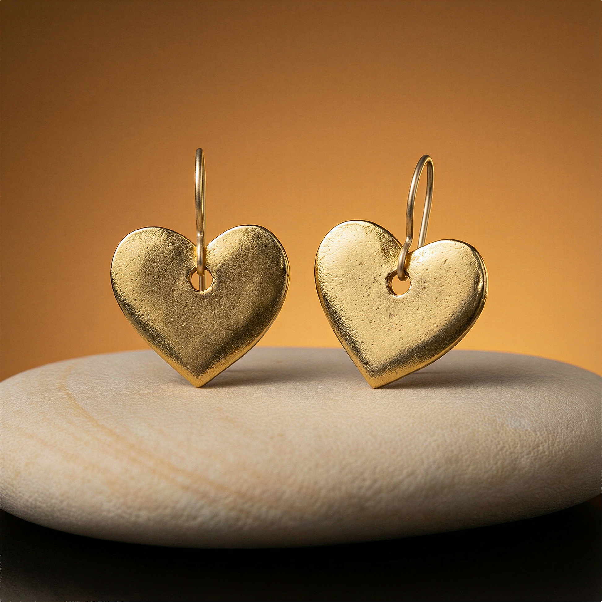 Antique gold heart mini flat tag charm in refined studio setting highlighting warm citrine-like glow and textures