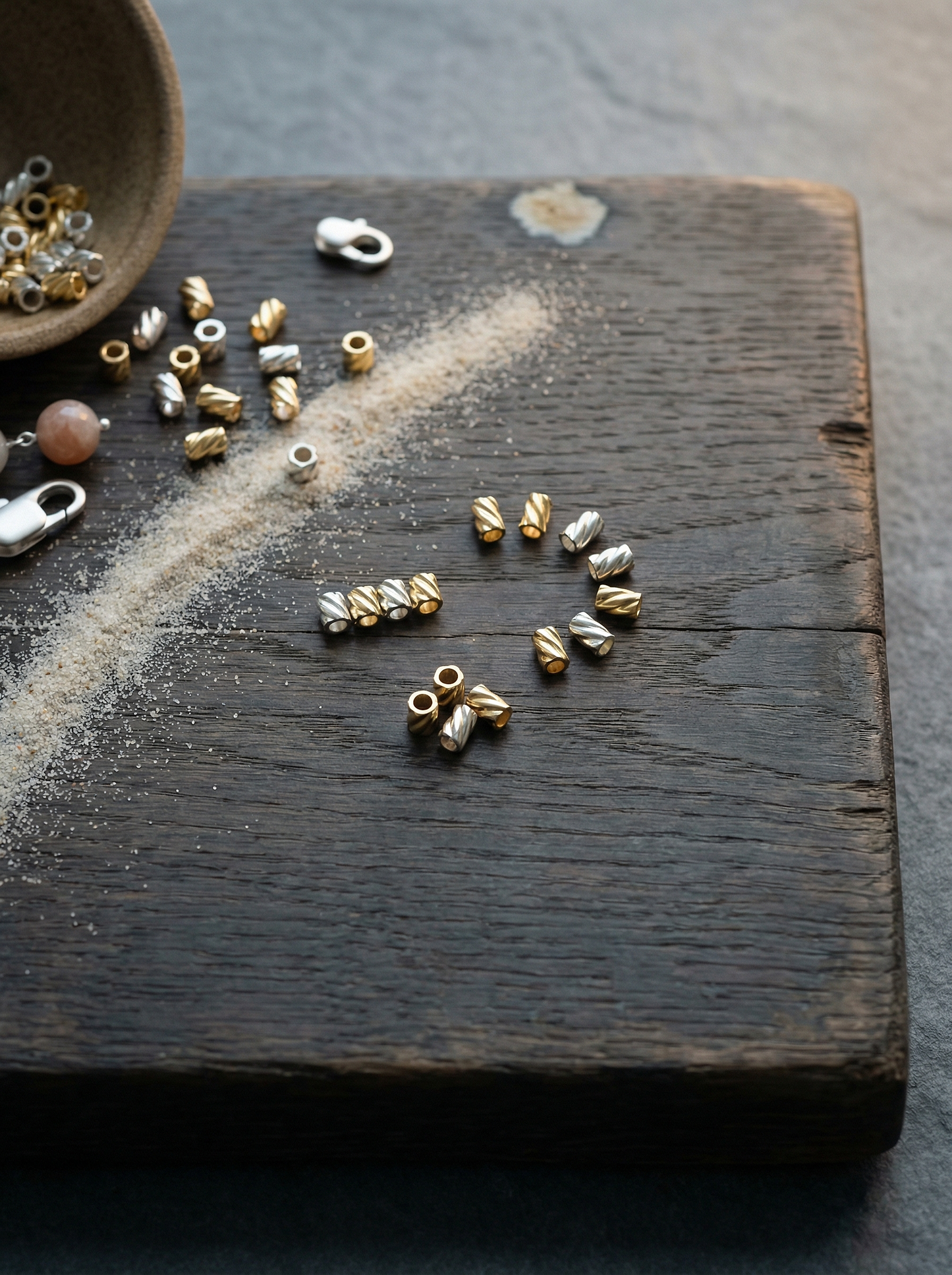 Silver and gold 2x2 twist crimps on weathered oak with ceramic bowl and clasp